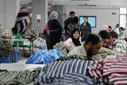 Chinese and Egyptian employees work together at the Chinese-owned Nile Textile Group factory in Port Said (AFP)