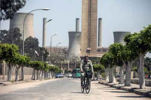 An Egyptian worker rides his bicycle near the Misr spinning and weaving factory in Mahala, 120km north Cairo (AFP)