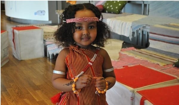 Little Somali girl in Djibouti wearing the traditional guntiino, armlets, headband, henna, and jewellery