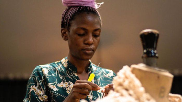 A fashion designer makes a blouse from local materials