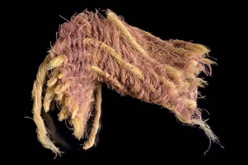 A fragment of purple fabric excavated from the Timna Valley, in southern Israel.PHOTO: AFP