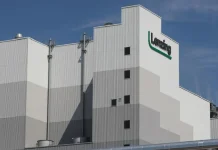 Lenzing Aktiengesellschaft: Preliminary Results Of Rights Offering Lenzing Group headquarters with financial growth chart overlay