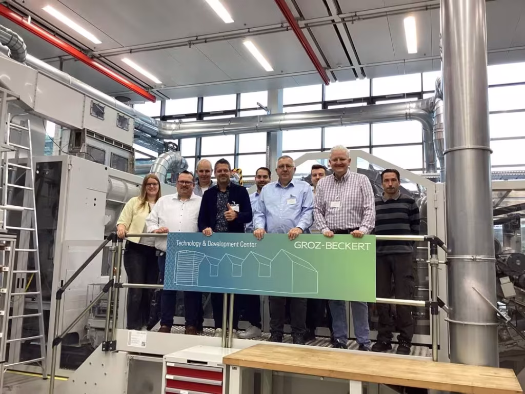 Groz-Beckert and Tretford Carpet engineers testing nonwoven machinery for premium goat hair carpet production at Groz-Beckert’s Technical Center.