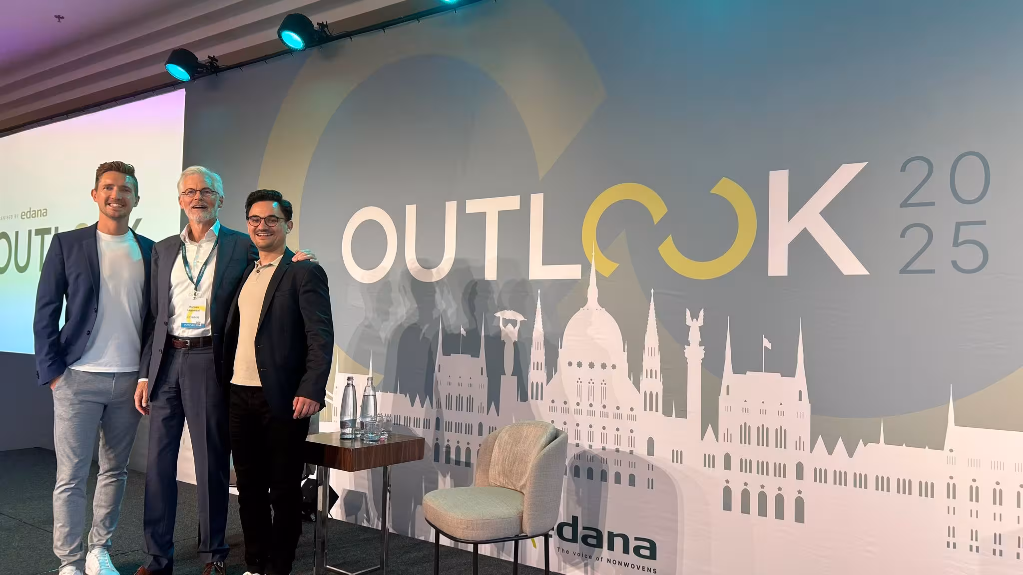 Conference hall at OUTLOOK 2025 in Budapest, gathering nonwovens industry leaders discussing sustainability and innovation.