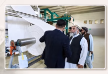 Industry Shows Signs of Growth Through Expanding Cotton Trade and Regional Cooperation Minimal textile industry header featuring a centered cotton manufacturing factory photo with business cooperation elements and regional textile trade design.