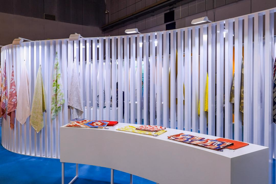 Visitors exploring innovative home textile products at Intertextile Shanghai Home Textiles exhibition.