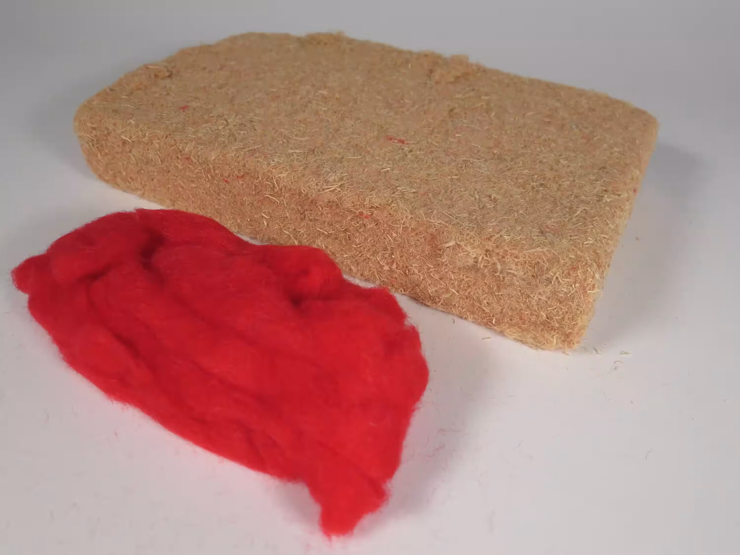 Red-dyed CAP Staple Fibers and Wood Fiber Insulation Board.